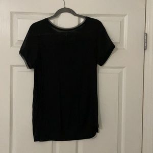 H&M black top with zipper detail on back.